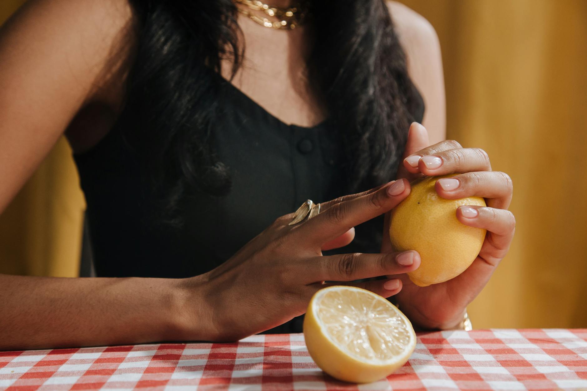 A blue silicone clitoral vibrator held in hand, symbolizing gentle sensation recovery